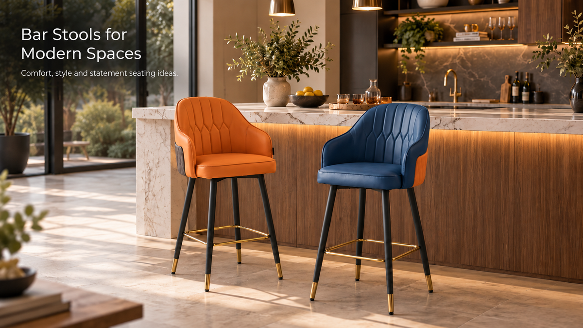 Blue and orange leather bar stools with gold footrests and black legs at a marble kitchen island, modern bar chairs with quilted backs in a warm, sunlit home bar setting.