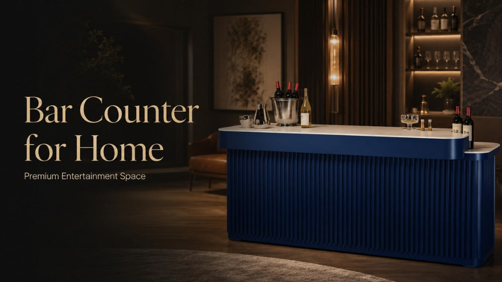 ARGMAC Baron bar counter with a white stone bar counter top, navy blue fluted wood, wine bottles and an ice bucket on it, in a warm lounge with pendant lights and a lit bar shelves.