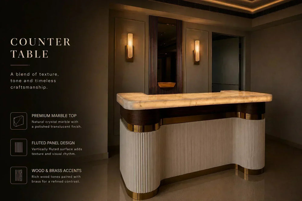 Sierra bar counter by ARGMAC, with a crystal marble top, fluted cream base, and brass trim, set in a warm-lit home bar corner.