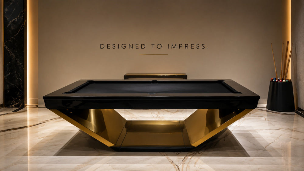 ARGMAC Rameses bespoke pool table with a glossy black pool table top and a bold golden, angular pedestal base, set against a marble wall with cue sticks and balls displayed nearby.
